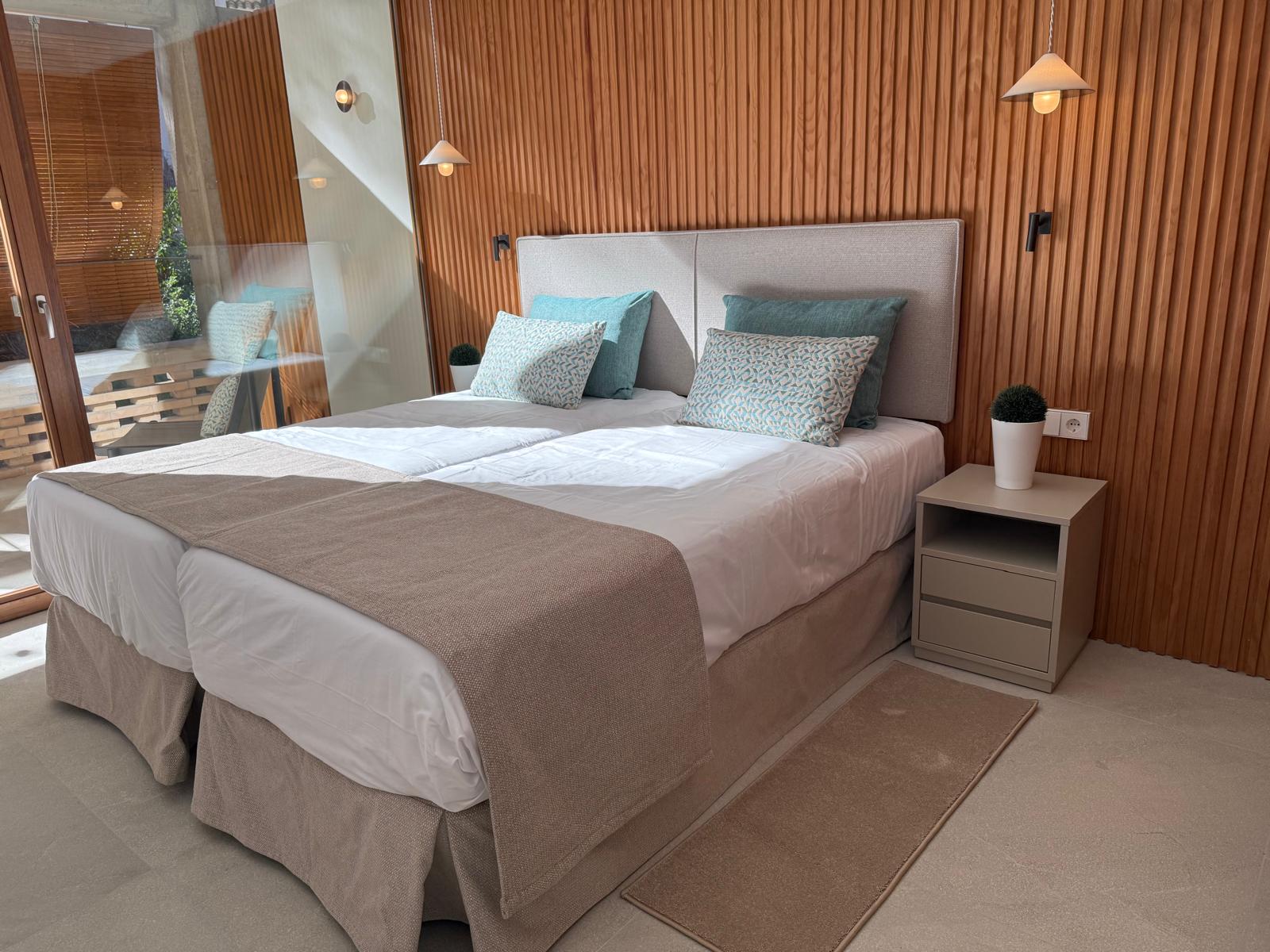 Foundation suite bedroom with twin beds and warm timber walls
